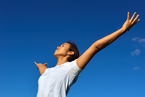 a lady opening arms towards the sky