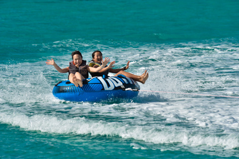 people on a two-rider tube