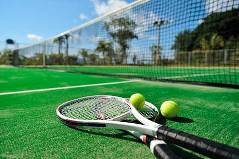 Tennis balls and rackets in the court