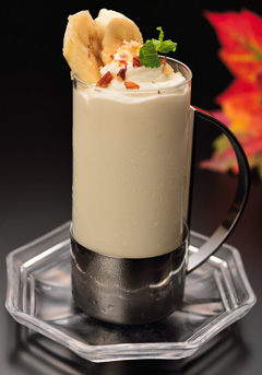 white drink with sliced banana on
